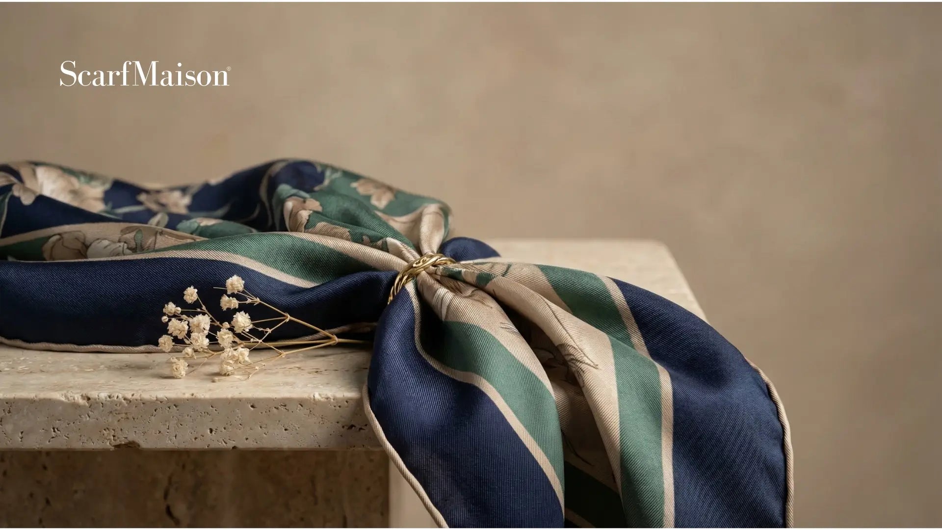 Navy blue and teal striped silk scarf with floral pattern, tied in knot Image