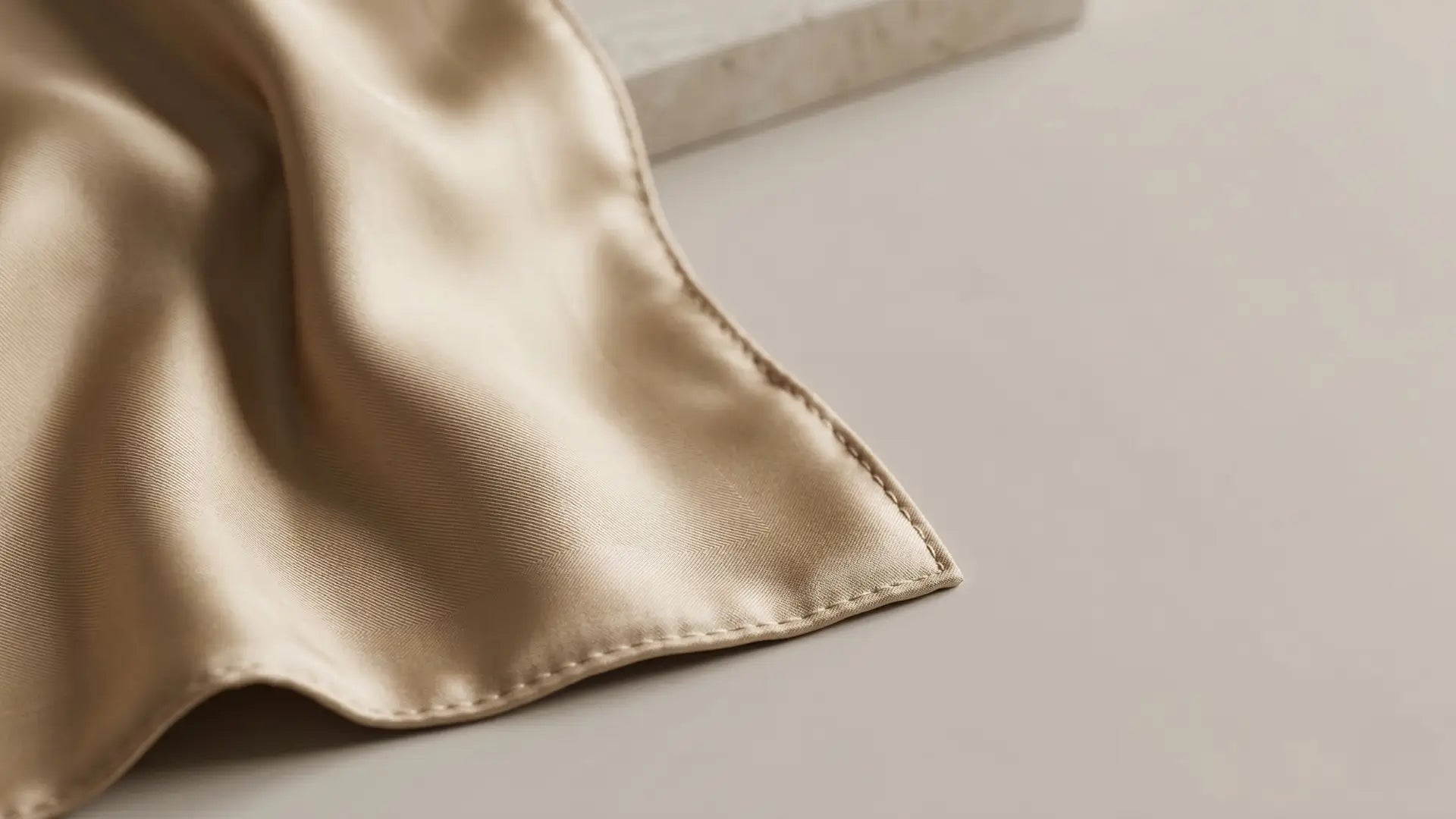Soft champagne silk pocket square with stitched edges Image