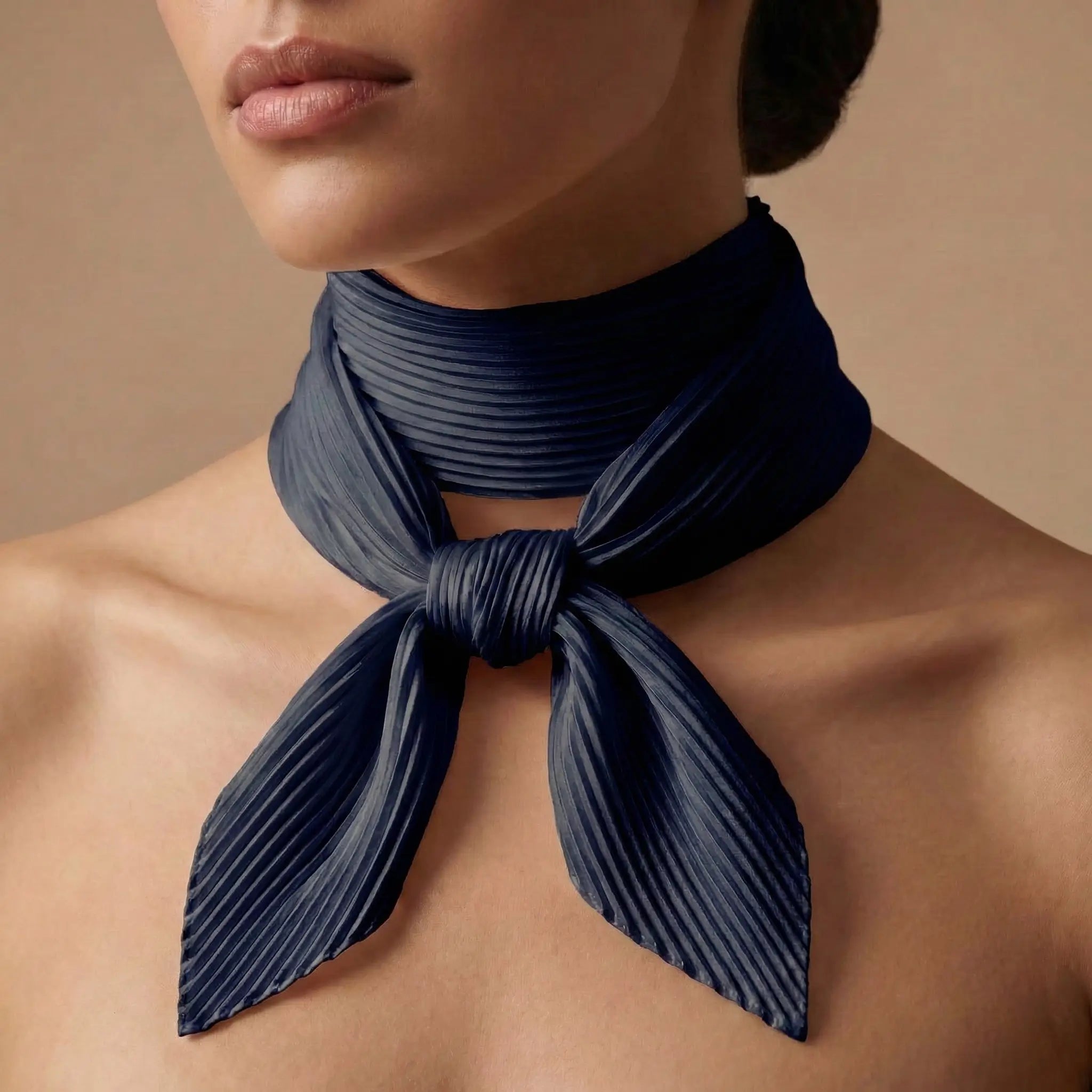 Navy blue pleated silk scarf knotted around neck in Black Scarf collection Image