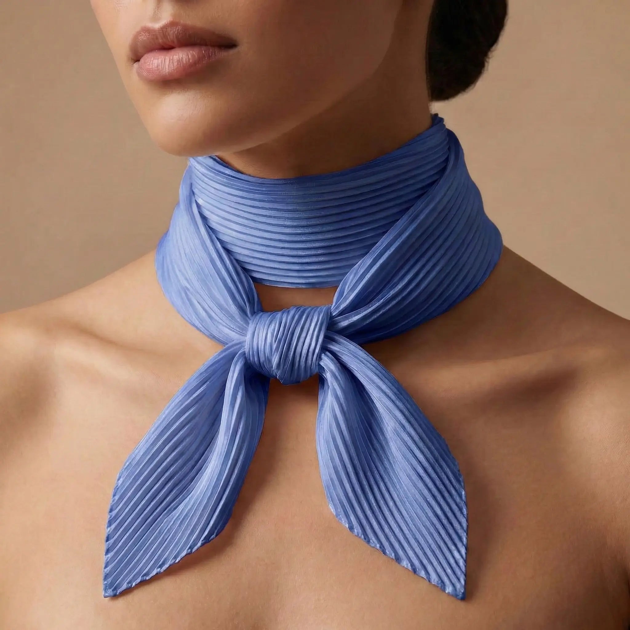 Blue Scarf collection: soft pleated blue scarf tied in neat neck knot Image
