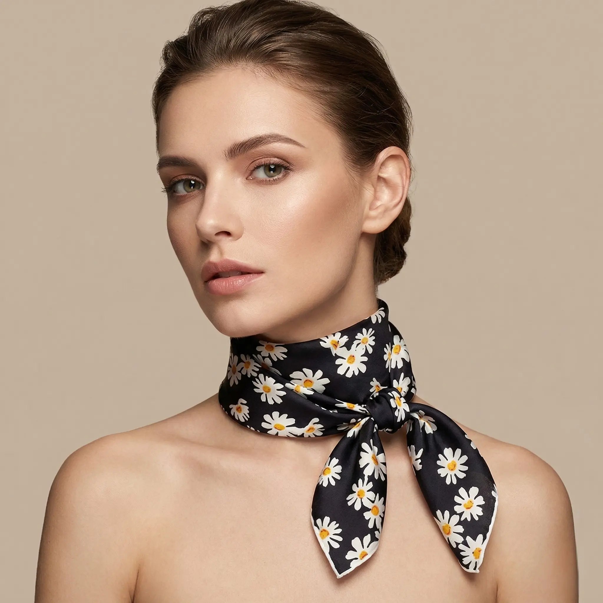 Black silk scarf with white daisy flowers and yellow centers, neatly knotted Image