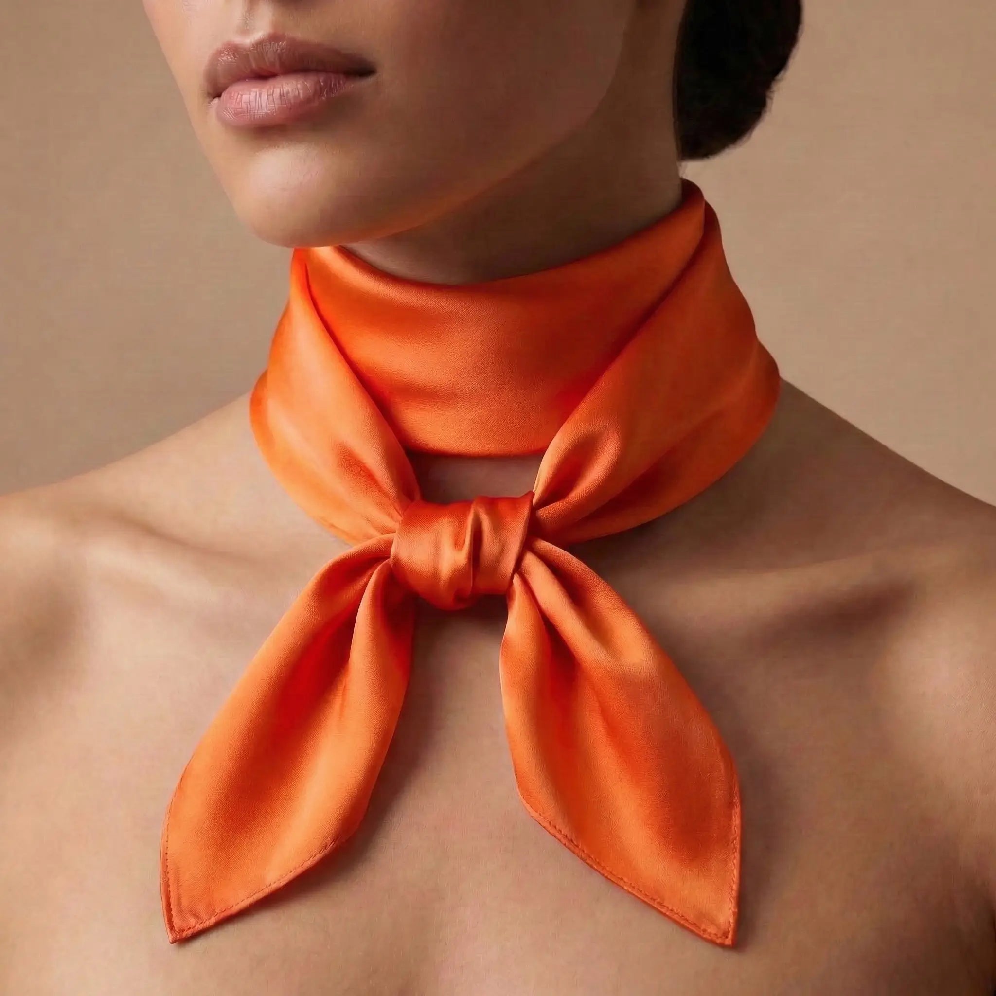 Vibrant orange silk scarf in neat bow from Orange Scarf collection Image
