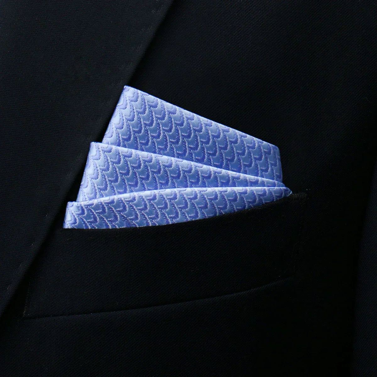 Light blue pocket square with subtle wave pattern in textured fabric Image