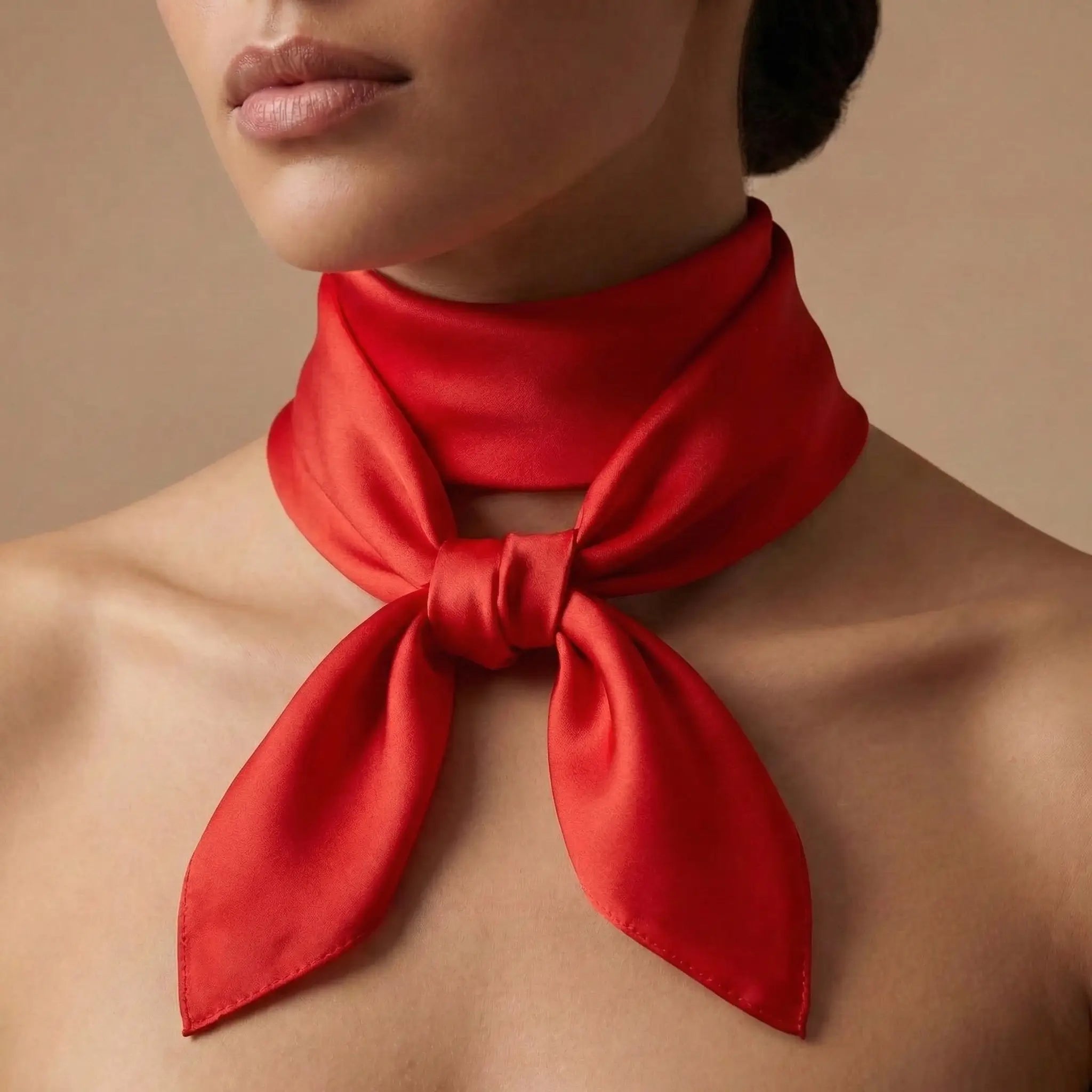 Vibrant red silk scarf tied in neat bow around neck from Red Scarf collection Image
