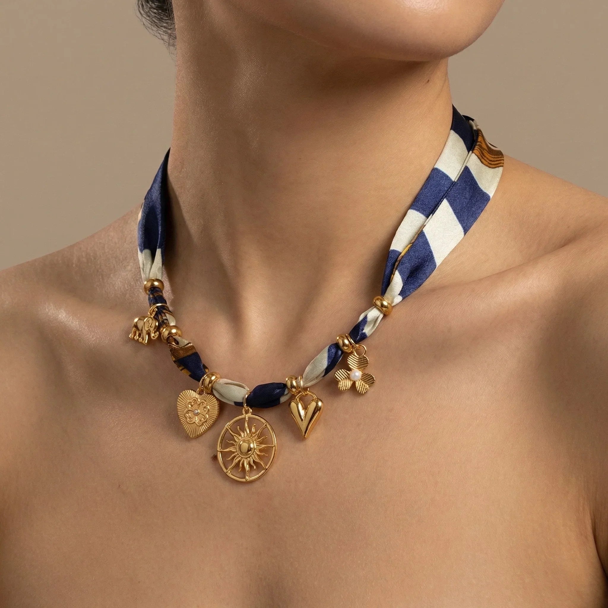 Navy white striped silk scarf necklace with gold heart sunburst leaf charms Image