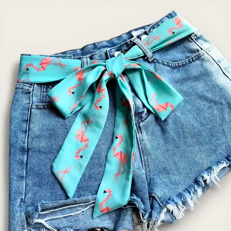 Turquoise flamingo bandana scarf belt tied in bow on denim shorts
