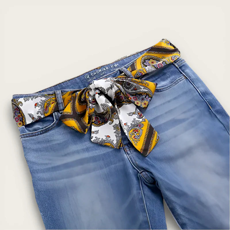 Vibrant yellow white paisley Belt Scarf Fashion tied as bow on blue jeans