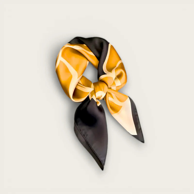 Luxurious black and gold silk scarf with elegant knot and abstract patterns