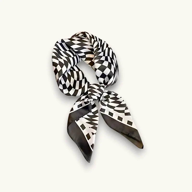 Black and white geometric patterned silk scarf tied in a knot