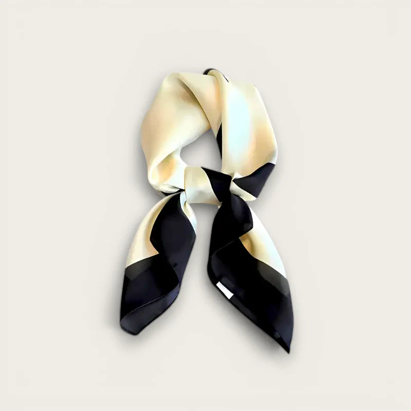 Sleek black and cream silk neck scarf tied in neat knot with satin folds