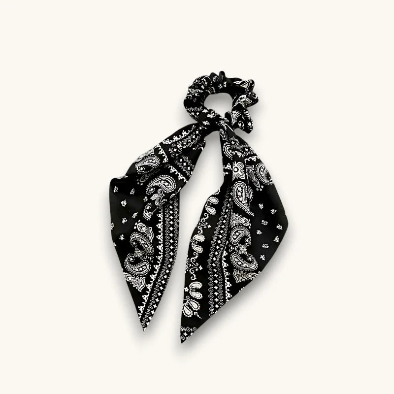 Black bandana scrunchie with white paisley pattern on soft fabric
