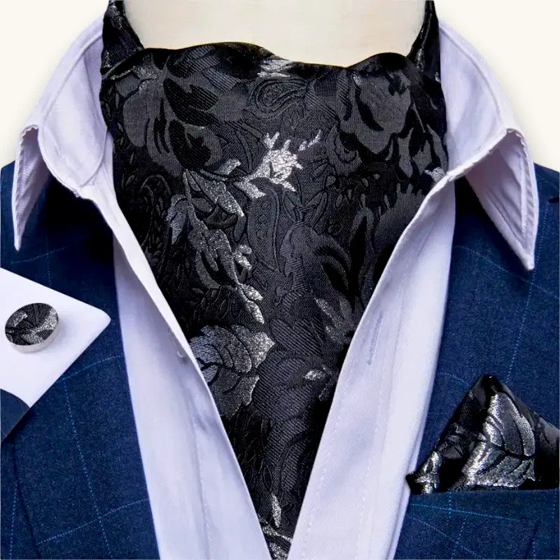 Black satin Ascot cravat with silver floral embroidery on blue suit shirt