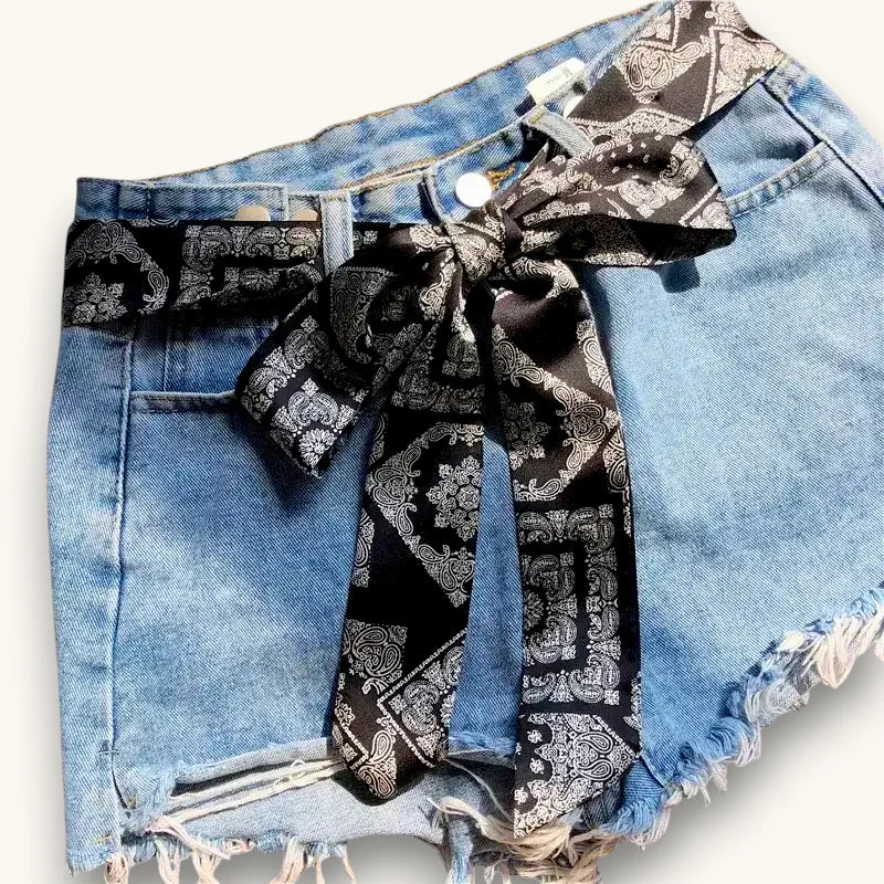 Black and silver paisley bandana bow belt on light-wash denim shorts