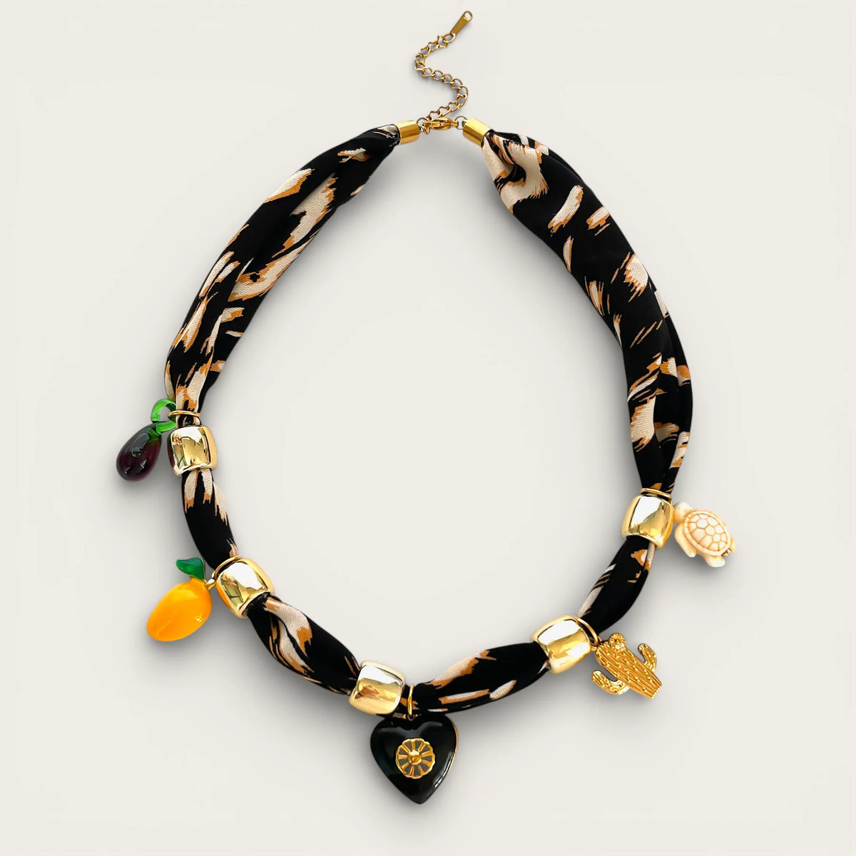 Black scarf necklace with beige zebra print and gold charms