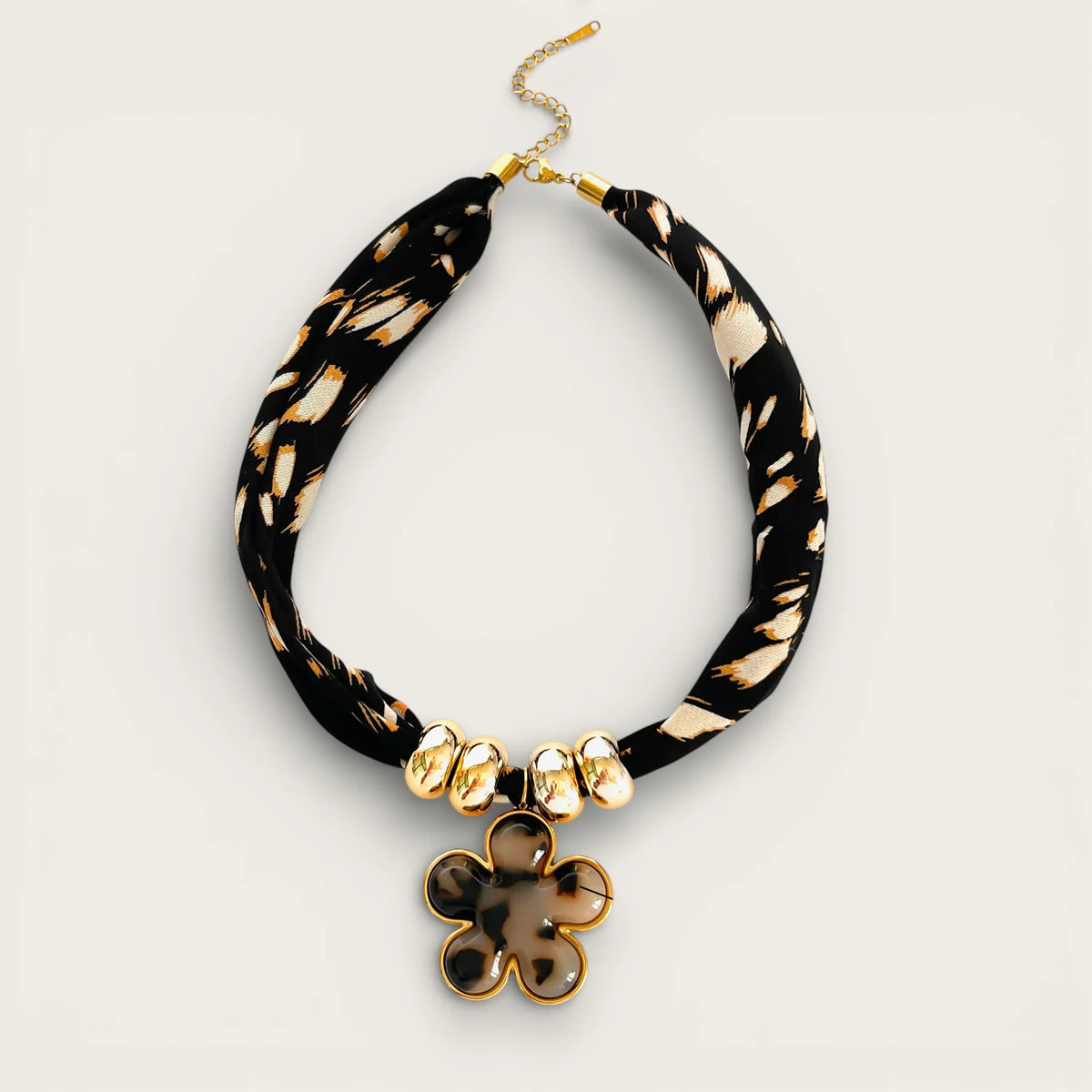 Black and gold feather choker necklace with tortoiseshell flower pendant