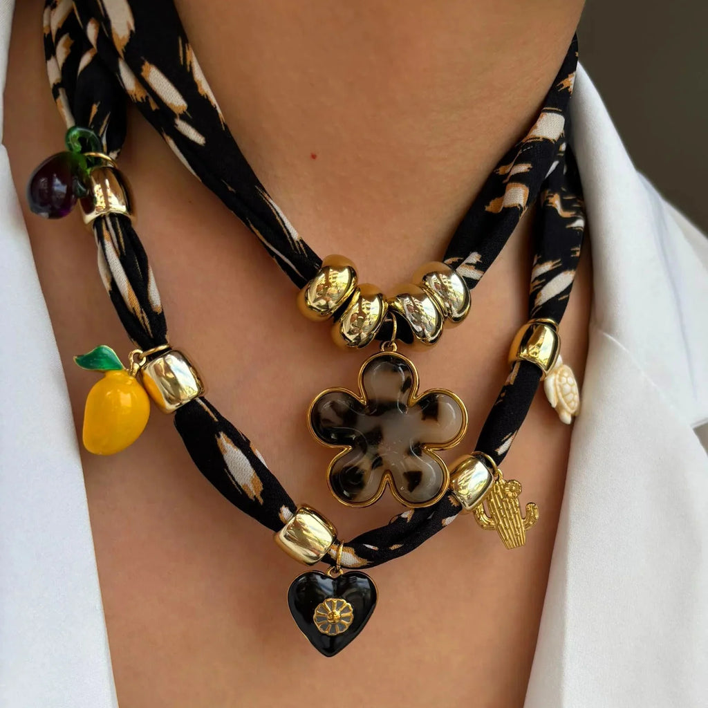 Black scarf necklace with gold beads, tortoiseshell flower, lemon, heart, cactus charms
