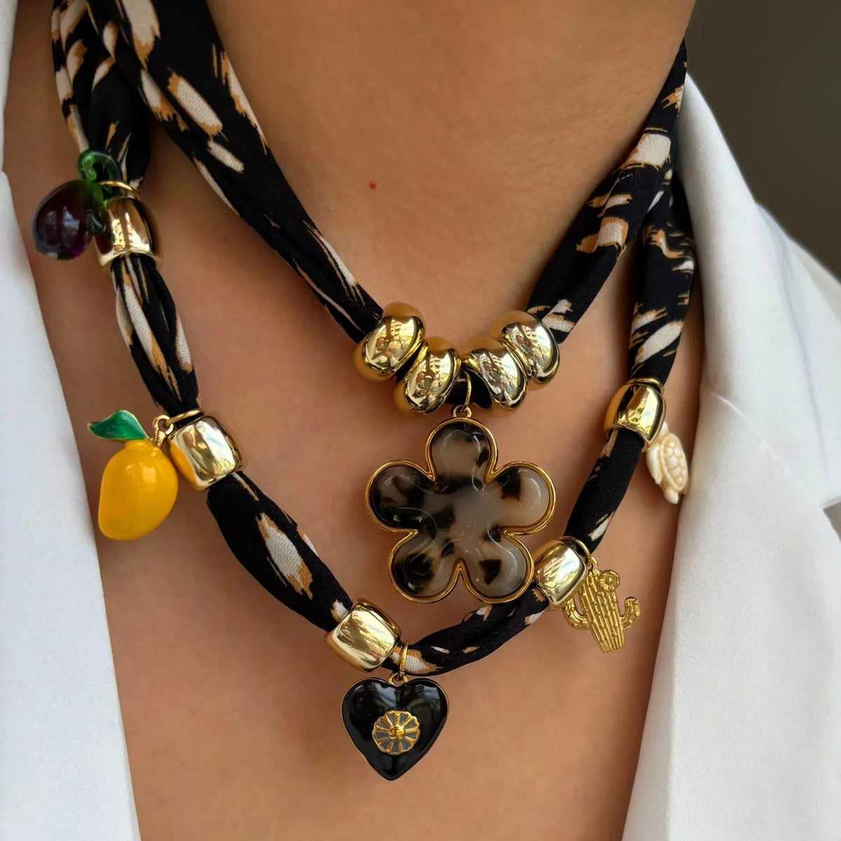 Black scarf necklace with gold beads, tortoiseshell flower, lemon, heart, cactus charms