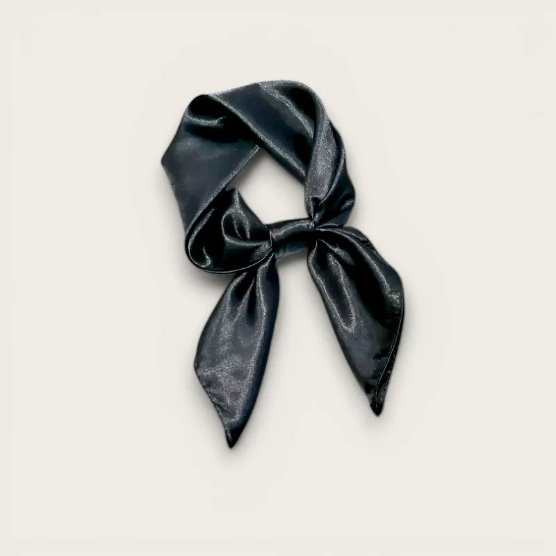 Black silk scarf tied in a neat bow on satin