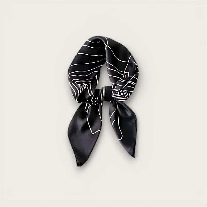 Black square silk scarf with white geometric line pattern tied in knot