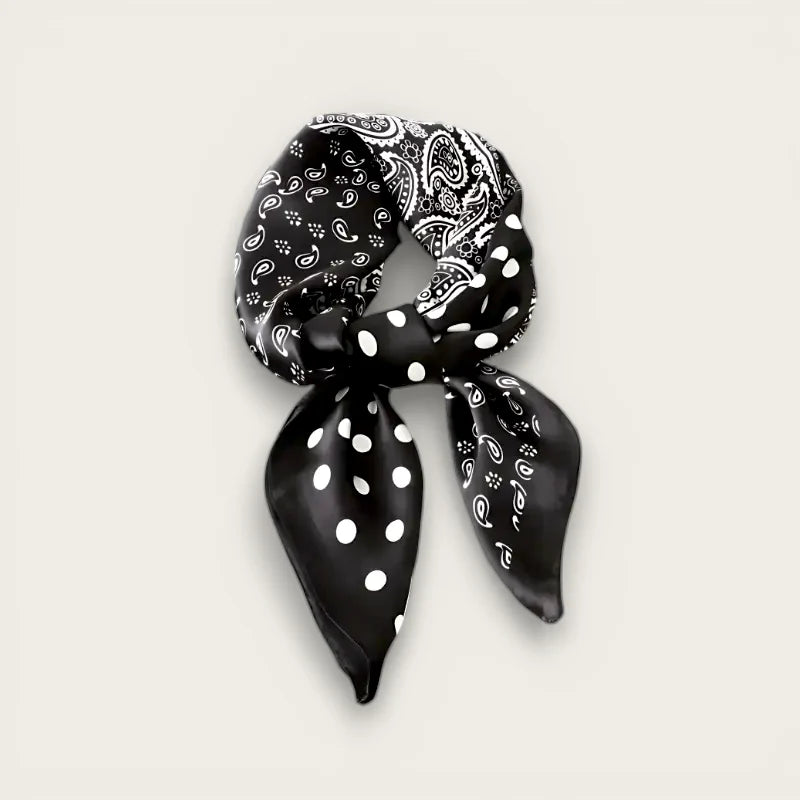 Black white polka dot silk scarf with paisley pattern, neatly knotted