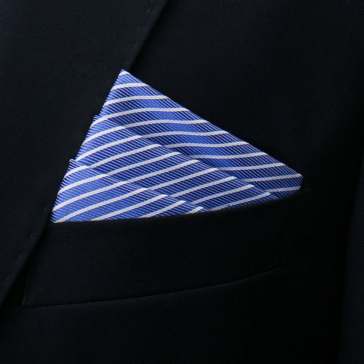 Blue and white striped silk pocket square folded in black suit jacket