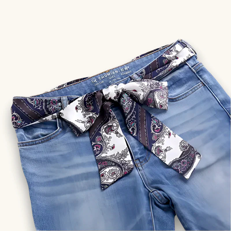 Navy and white paisley silk scarf belt tied in bow around blue jeans waist