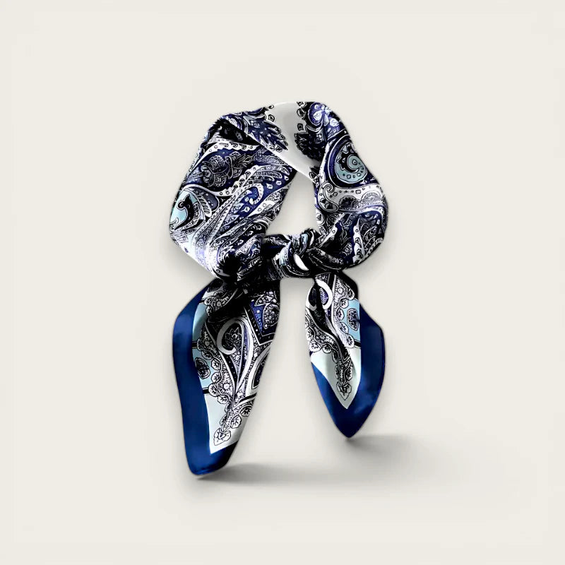 Blue and white paisley silk scarf tied in knot with flowing ends