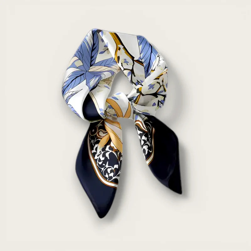 Elegant blue and gold floral silk scarf tied in knot with pointed ends