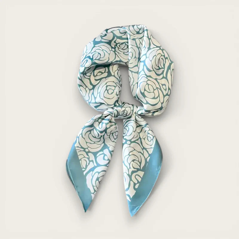 Blue Flower Scarf: light blue silk with white rose pattern, neatly knotted