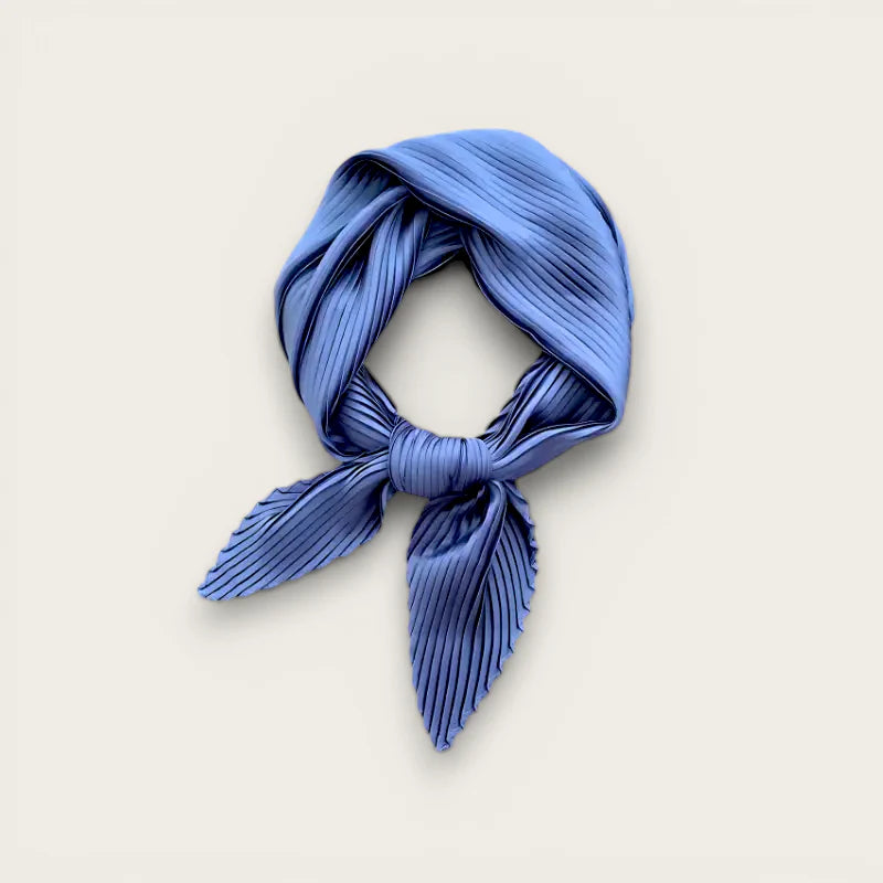 Blue pleated silk neck scarf tied in neat knot with tapered ends