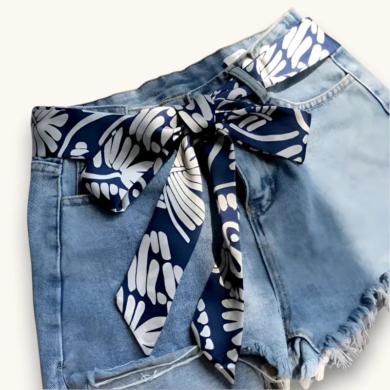 Blue Scarf Belt: navy blue and white silk scarf tied as bow on denim shorts