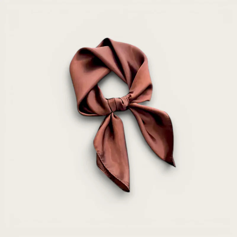 Brown head scarf in soft dusty rose silk with neat knot and flowing tails