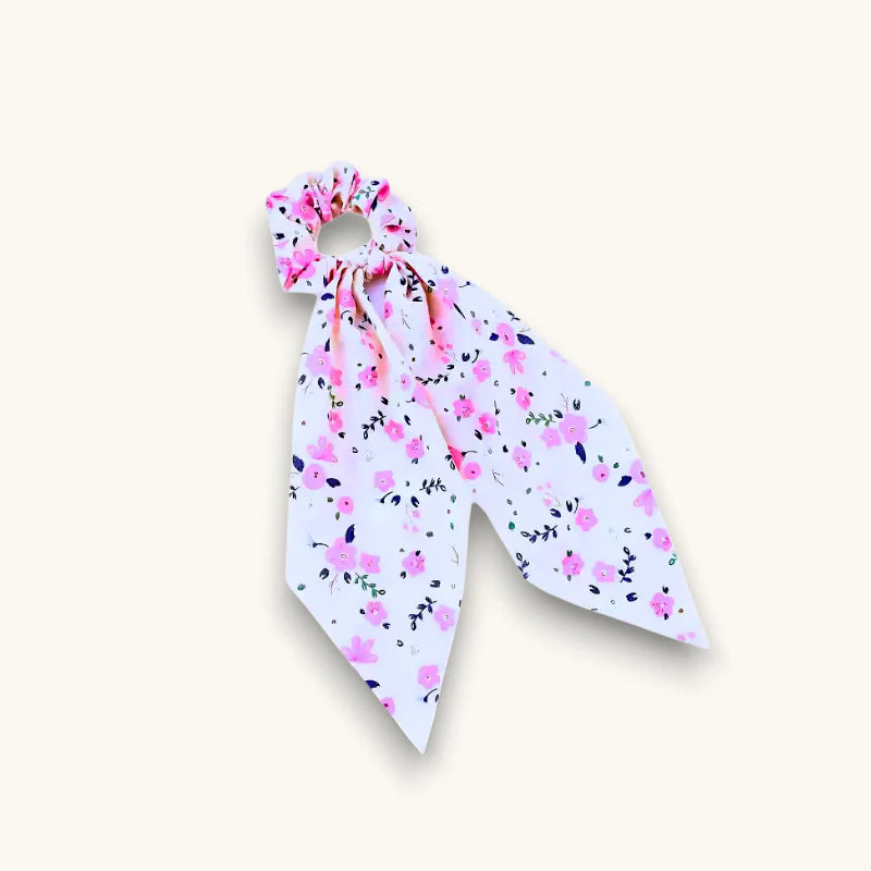 Chiffon bow scrunchie with pink floral pattern and green leaves ribbon tail