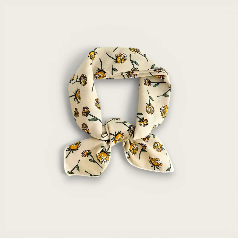 Cream-colored cotton hair scarf with yellow flowers and green stems, knotted