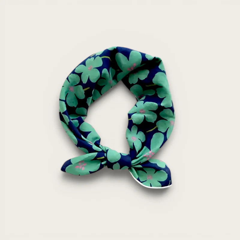 Navy blue silk Cotton Neck Scarf with green floral pattern and pink accents, knotted