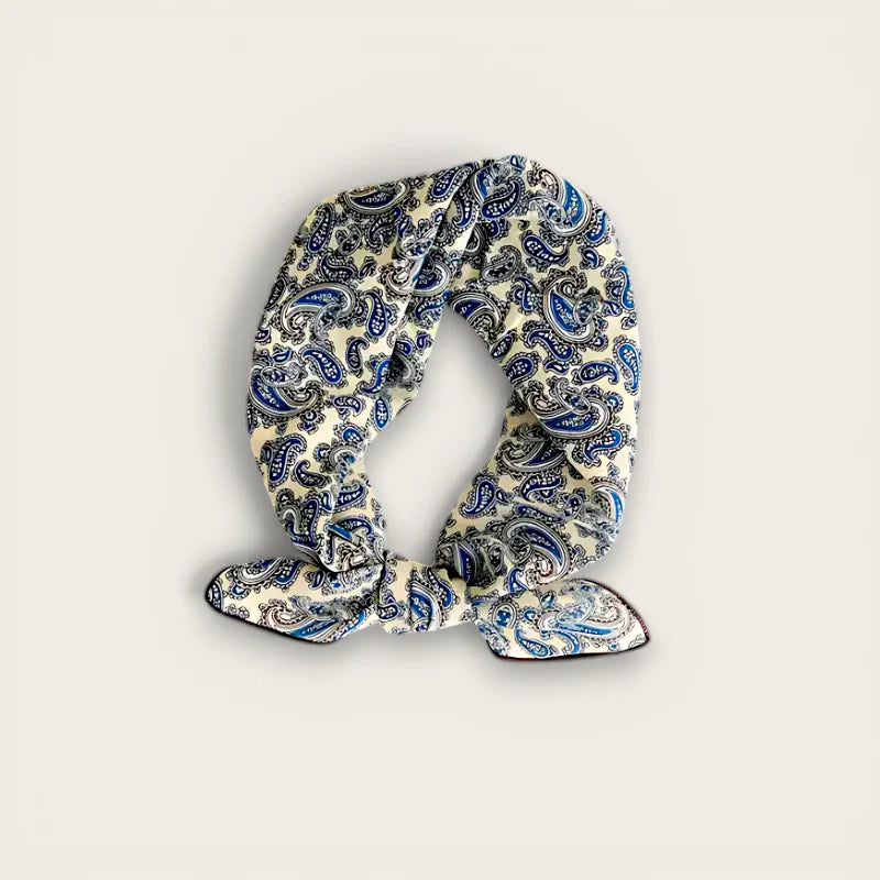 Cream-colored silk paisley scarf with blue and black pattern, neatly knotted