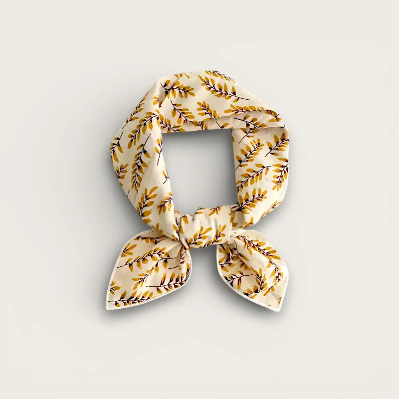 Cream cotton scarf wrap with golden-brown leaf pattern in neat knot