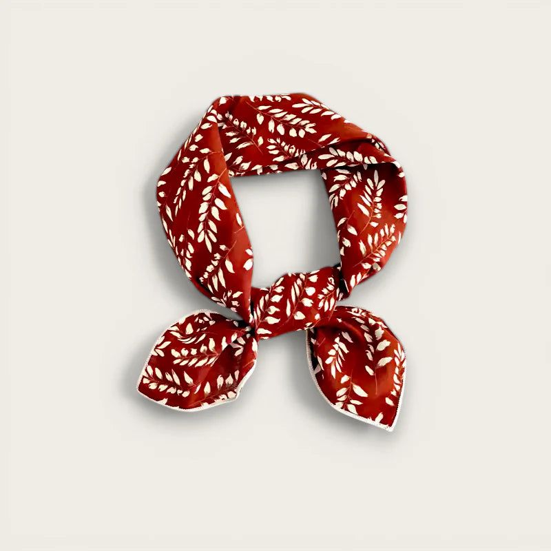 Dark red cotton scarf with red silk and white leaf pattern in neat knot
