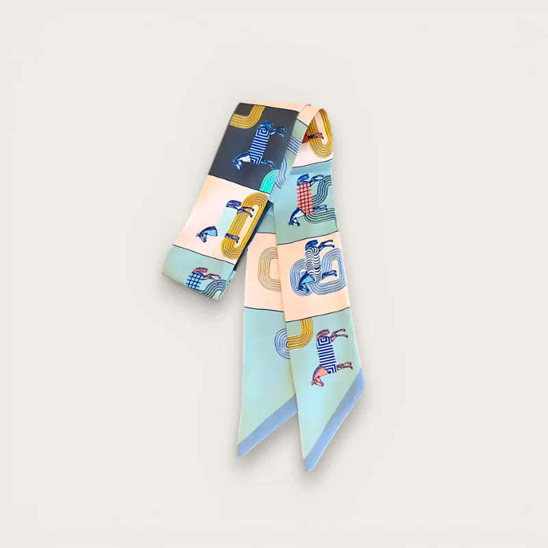 Designer bag scarf with vibrant patterned silk, whimsical figures in pastel hues
