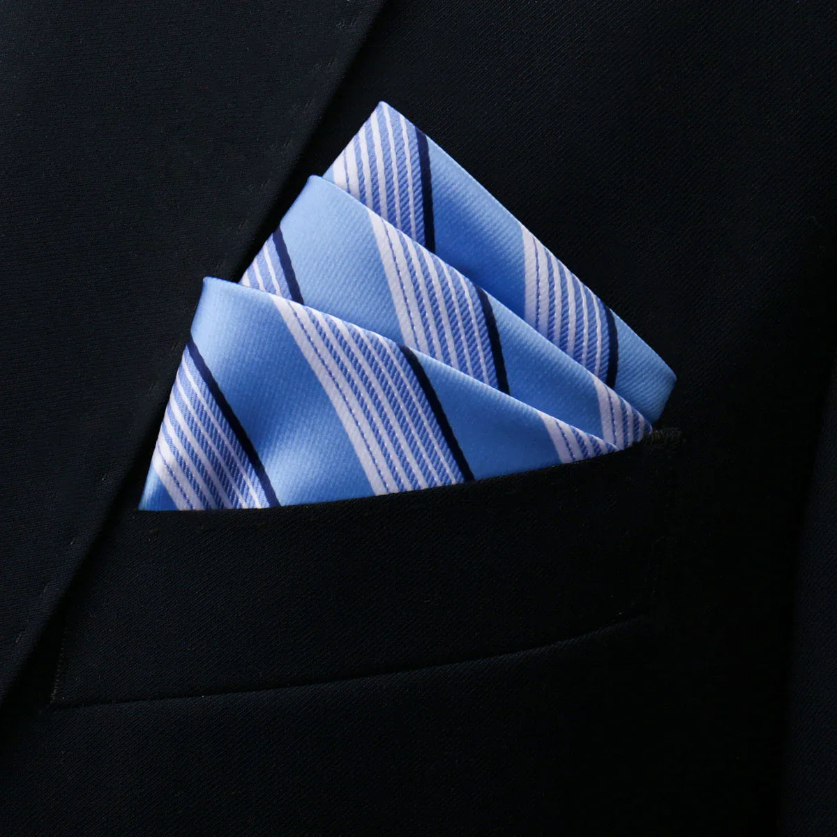 Dusty Blue pocket square with white and navy diagonal stripes in suit pocket