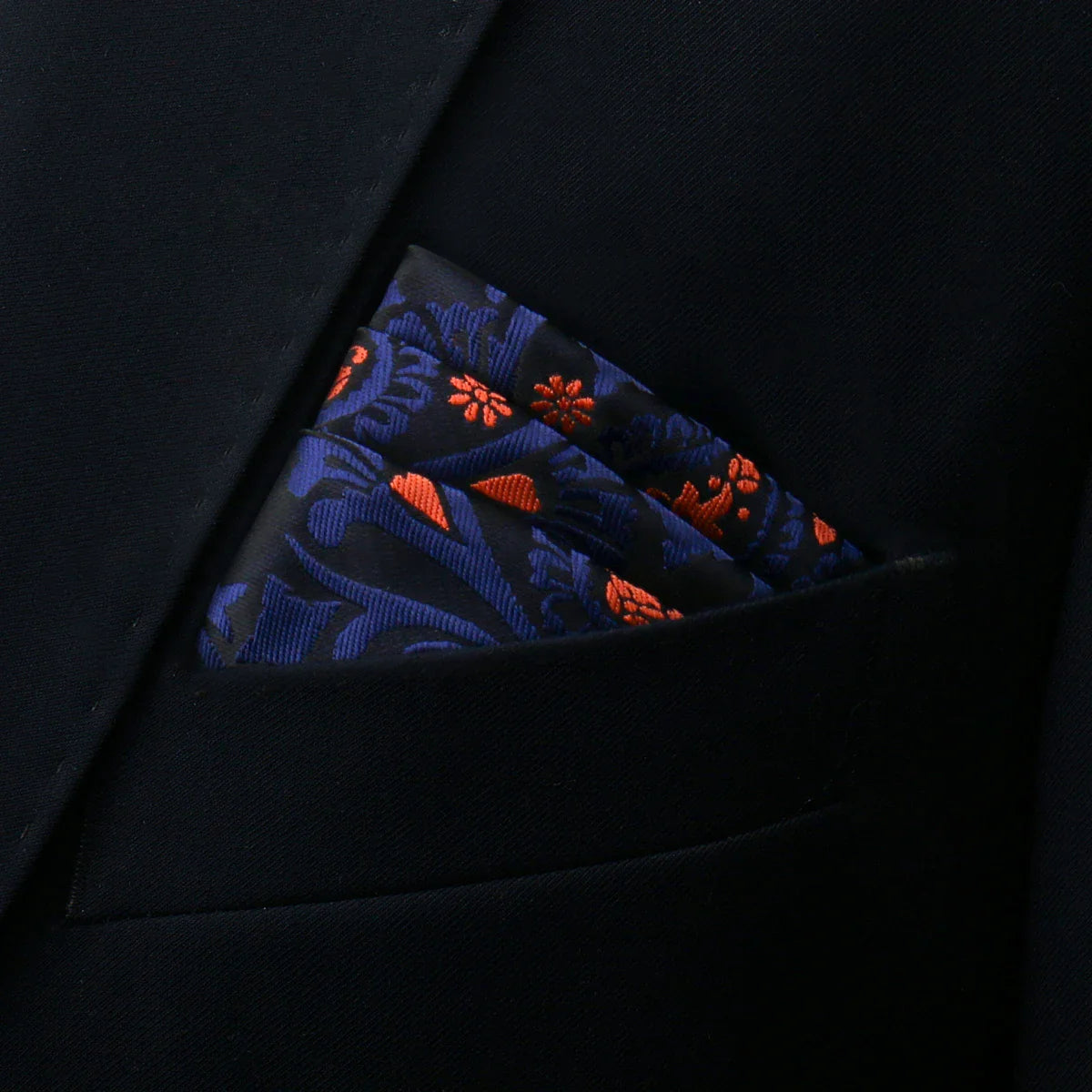 Navy blue silk Floral Pocket Square with orange floral embroidery in black suit jacket