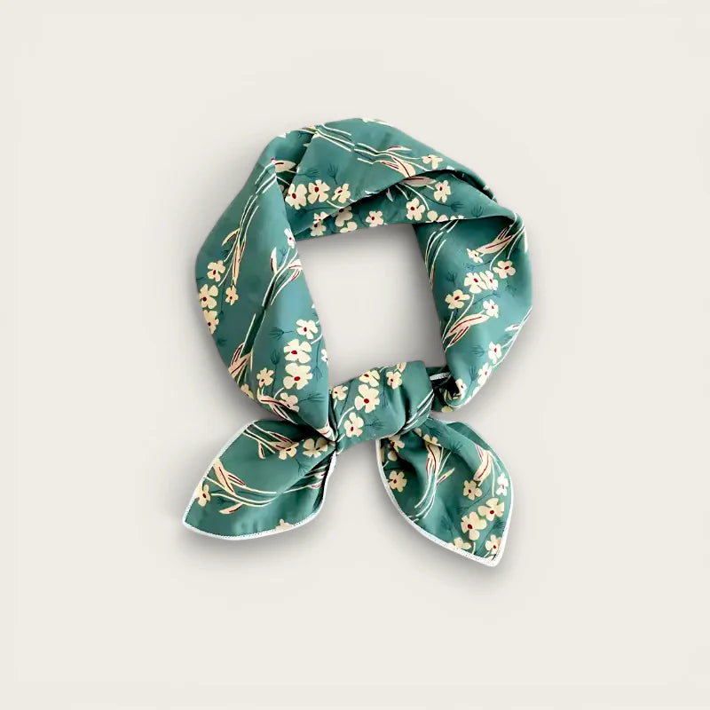 Teal floral silk scarf with white pink blossoms tied in knot