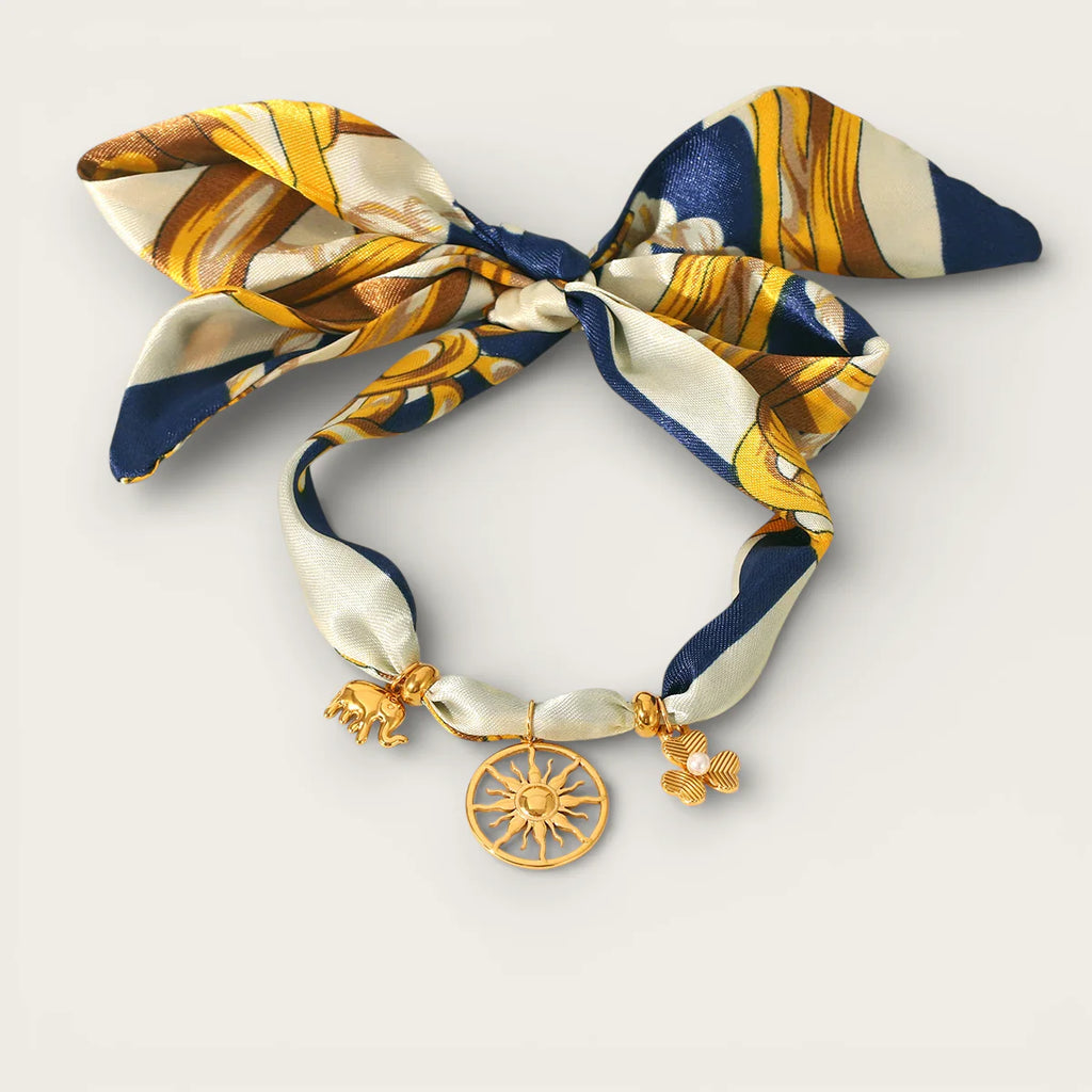 Gold Scarf Necklace: navy blue silk scarf with gold cream pattern, bow, sun elephant flower charms