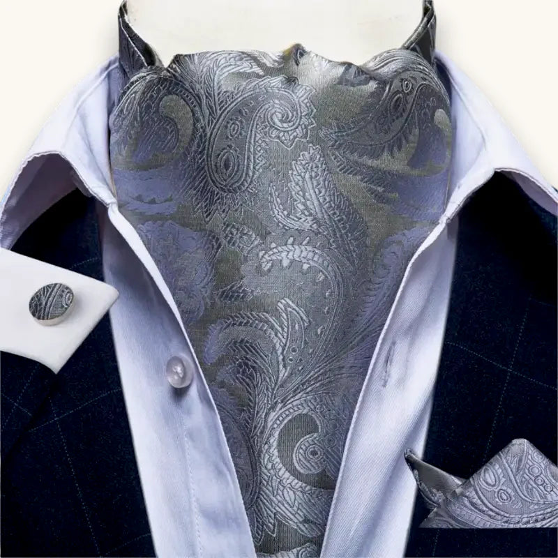 Grey Ascot Tie: silver-gray paisley cravat on white shirt, dark suit
