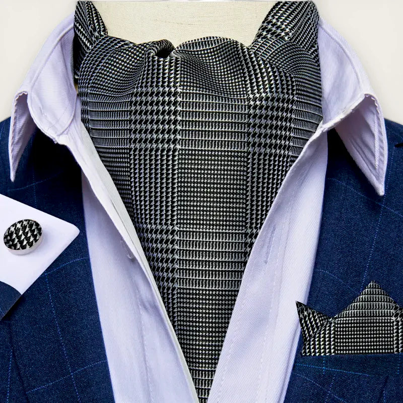 Grey silk ascot in black and white houndstooth with navy suit