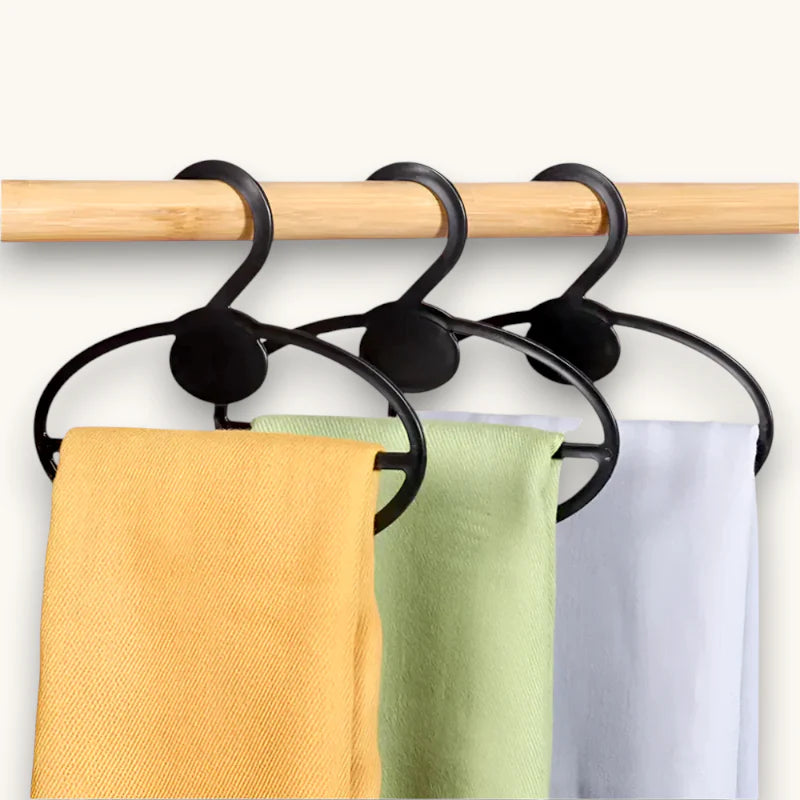 Black curved plastic hangers holding yellow green white towels in Hanging Scarf Organizer