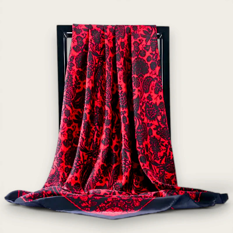 Large black red silk scarf with rich red fabric and intricate black floral embroidery on dark frame