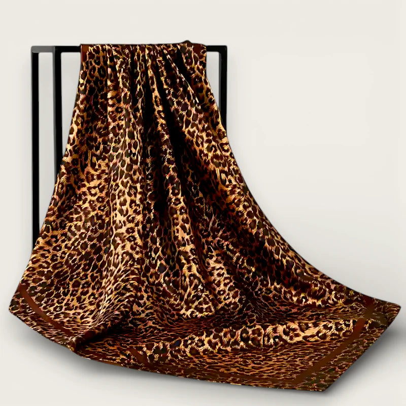 Large leopard print scarf in brown gold with satin finish on black rack