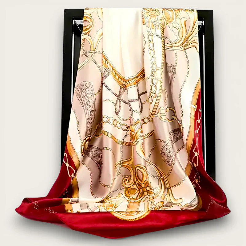 Luxurious cream silk scarf with gold burgundy chain patterns on black frame
