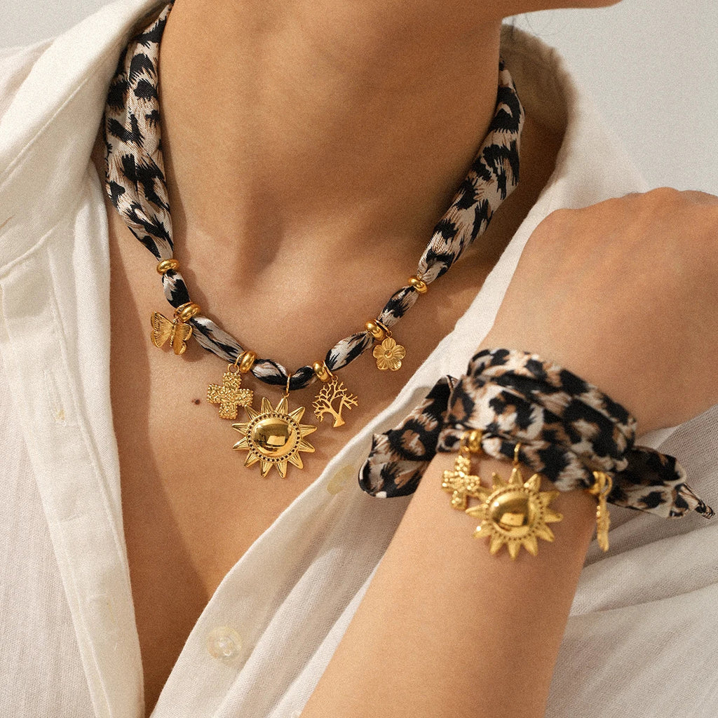Leopard Scarf Necklace: gold-toned set with leopard-print cords, sun tree butterfly flower charms